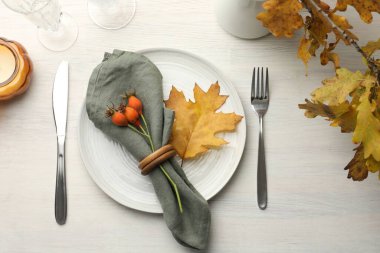 Beautiful table setting with autumn decor on white wooden background, flat lay