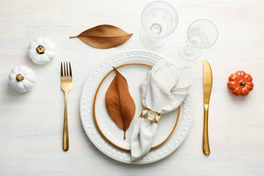 Beautiful table setting with autumn decor on white wooden background, flat lay