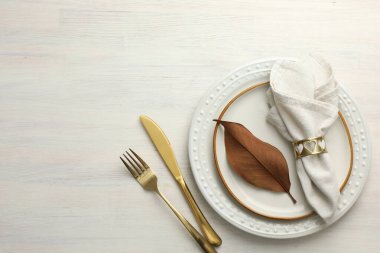 Beautiful table setting with autumn decor on white wooden background, flat lay. Space for text