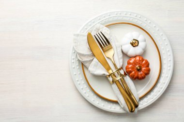 Beautiful table setting with autumn decor on white wooden background, top view. Space for text