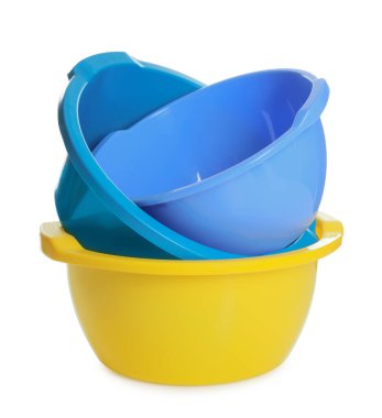 Three colorful plastic basins isolated on white