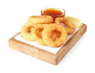 Tasty fried squid rings, lemon and sauce isolated on white