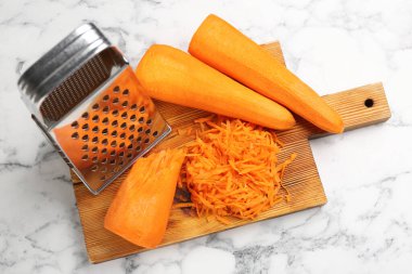 Beyaz mermer masa üzerinde rendelenmiş havuç, üst görünüm