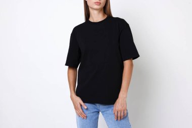 Beyaz arka planda siyah tişört giyen kadın, yakın plan. Tasarım için model