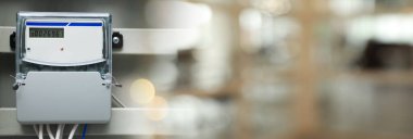 Electricity meter in fuse box on wall indoors. Banner design