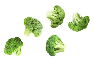 Fresh green broccoli flying in air on white background