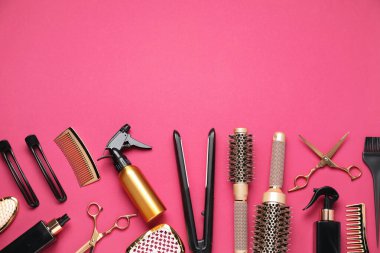 Different hair styling tools on pink background, flat lay. Space for text