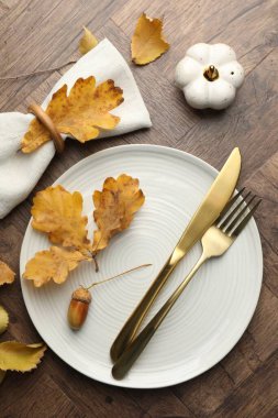 Beautiful table setting with autumn decor on wooden background, flat lay