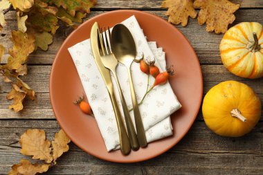 Beautiful table setting with autumn decor on wooden background, flat lay