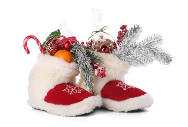 Saint Nicholas day. Boots with treats and festive decor isolated on white