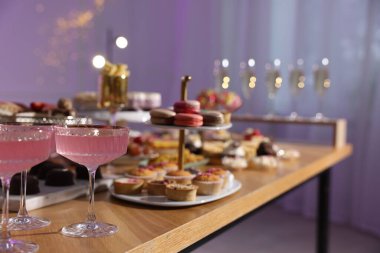 Buffet menu. Delicious desserts and drinks on table, selective focus