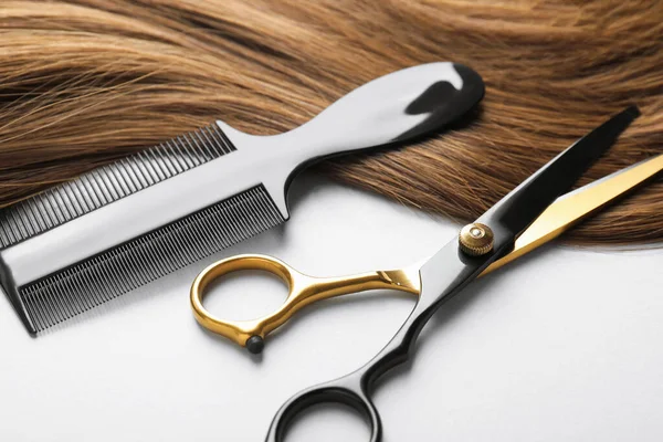 Güzel saç teli ve kuaför aletleri beyaz arka planda, yakın plan