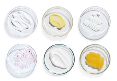 Petri dishes with cosmetic products on white background, top view