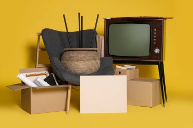 Garaj satışı. Sarı arkaplanda farklı kullanılmış eşyalar