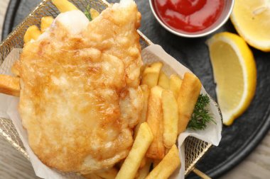 British Traditional Fish and chips served on wooden table, top view