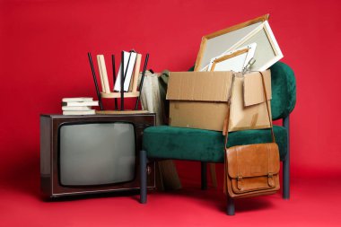 Garaj satışı. Kırmızı arkaplanda farklı kullanılmış şeyler