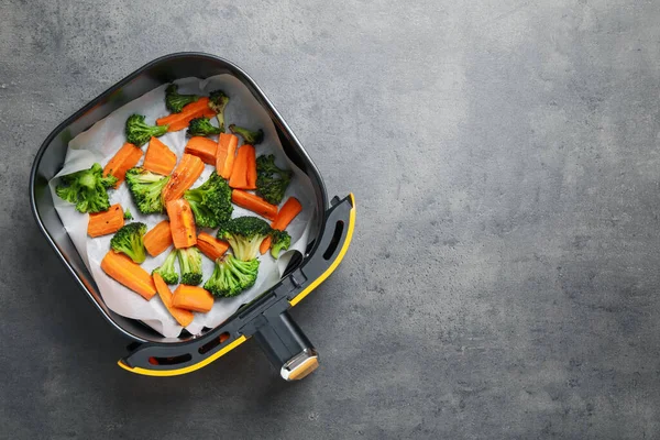 Gri masada, tava sepetinde ızgara sebzeler, üst manzara. Metin için boşluk
