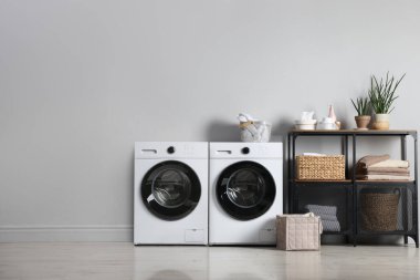 Geniş çamaşır odasında çamaşır ve çamaşır kurutma makinesi.