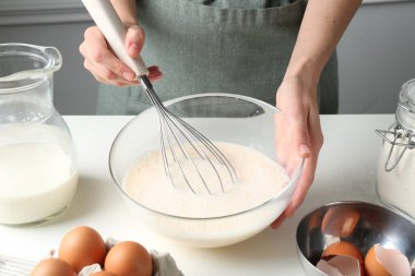 Beyaz masada hamuru hazırlayan kadın, yakın plan.