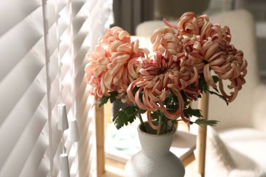 Güzel pembe kasımpatı çiçekleri vazoda ahşap rafta, yakın plan