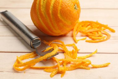 Portakal tadı, taze meyve ve zester aleti açık ahşap masada, yakın plan.