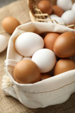 Different raw chicken eggs on table, closeup