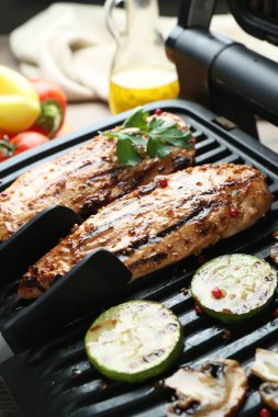 Lezzetli tavuk filetosu, mantar, kabak ve maşayla elektrikli ızgara.