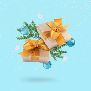 Noel ya da yeni yıl kutlaması. Hediye kutuları ve şenlikli dekorlar açık mavi arka planda havada uçuşuyor.
