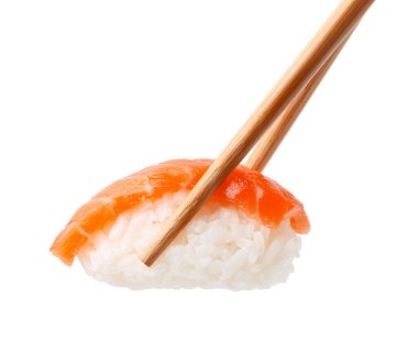 Chopsticks with delicious nigiri sushi isolated on white