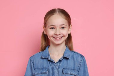 Pembe arka planda güzel bir kızın portresi.