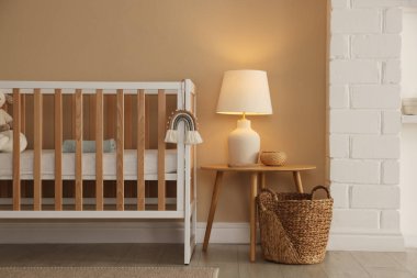 Beşik, masa ve dekorlu şık bir bebek odası. İç tasarım
