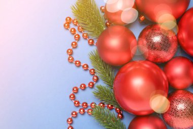 Noel baloları, ağaç dalları ve renkli arka planda bokeh ışıkları. Tebrik kartı tasarımı