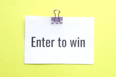 Sarı arka planda kazanmak için girin cümlesi ile kağıt not, üst görünüm