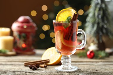 Cam, baharat ve Noel süsü katılmış lezzetli punç içeceği kahverengi arka planlı, bulanık ışıklı, yakın plan. Bokeh etkisi
