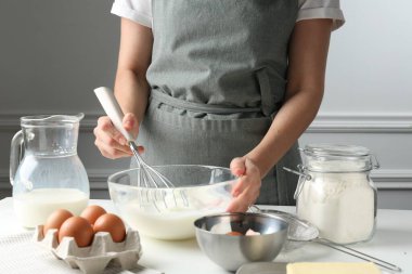 Beyaz masada hamuru hazırlayan kadın, yakın plan.