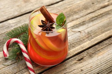 Bardakta kokteyl, baharat ve Noel süsü, ahşap masada, yakın plan. Metin için boşluk