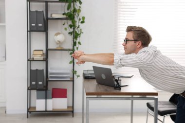 Genç İşadamı Ofiste Esneme Egzersizi Yapıyor