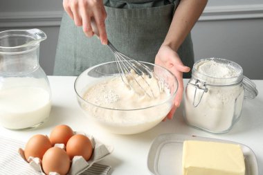 Beyaz masada hamuru hazırlayan kadın, yakın plan.