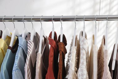 Farklı şık kıyafetler askıda asılı, kapalı, yakın çekim.