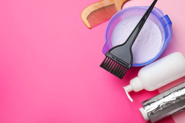 Profesyonel aletler ve saç boyama ürünleri. Renkli arka plan, düz yatak. Metin için boşluk
