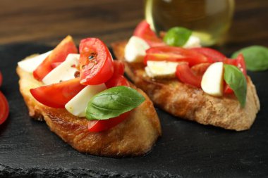 Mozarella peynirli, domatesli ve fesleğenli lezzetli bruschettalar, yakın plan.