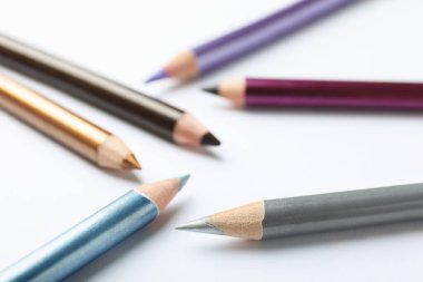 Beyaz arkaplanda renkli göz kalemleri, yakın plan