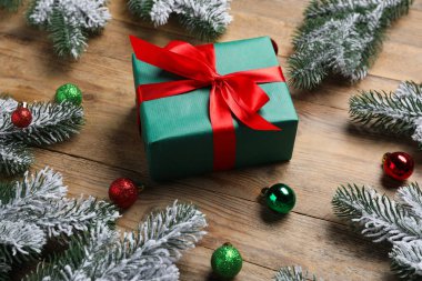 Ahşap arka planda süsleri ve hediyeleri olan güzel Noel ağacı dalları, yakın plan