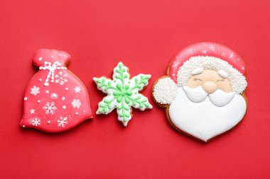 Kırmızı arka planda lezzetli zencefilli kurabiyeler, düz yatış. Noel hediyesi