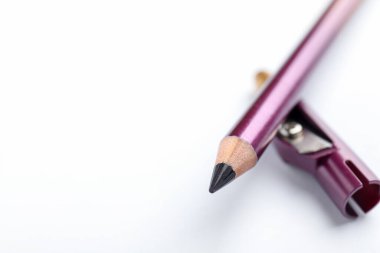 Mor göz kalemi ve beyaz arka planda keskinleştirici, yakın plan. Metin için boşluk