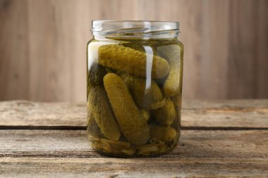 Kavanozda salatalık turşusu, ahşap masada, yakın plan.