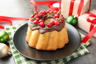 Yaban mersinli pasta, hediyeler ve gri masada Noel dekoru, yakın plan.