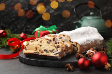Geleneksel Noel Stollen şekerli, baharatlı ve şenlikli siyah masa, yakın plan. Bokeh etkisi