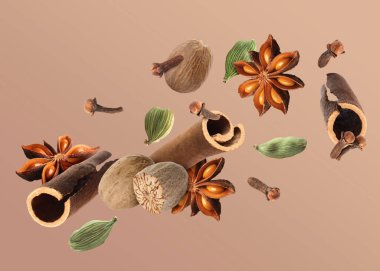 Noel içecekleri için farklı baharatlar ve kahverengi arkaplana düşen yemekler. Anason, kakule, tarçın, hindistan cevizi ve karanfil.