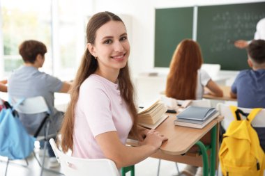 Teacher and students during lesson in classroom, selective focus